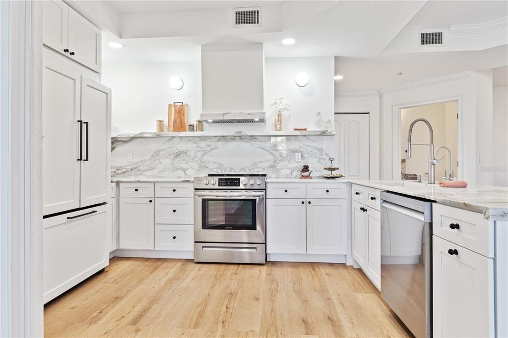 Open kitchen with designer fixtures and luxury finishes