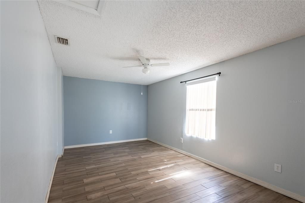 Spacious primary bedroom with plenty of space to add a closet on the back wall.