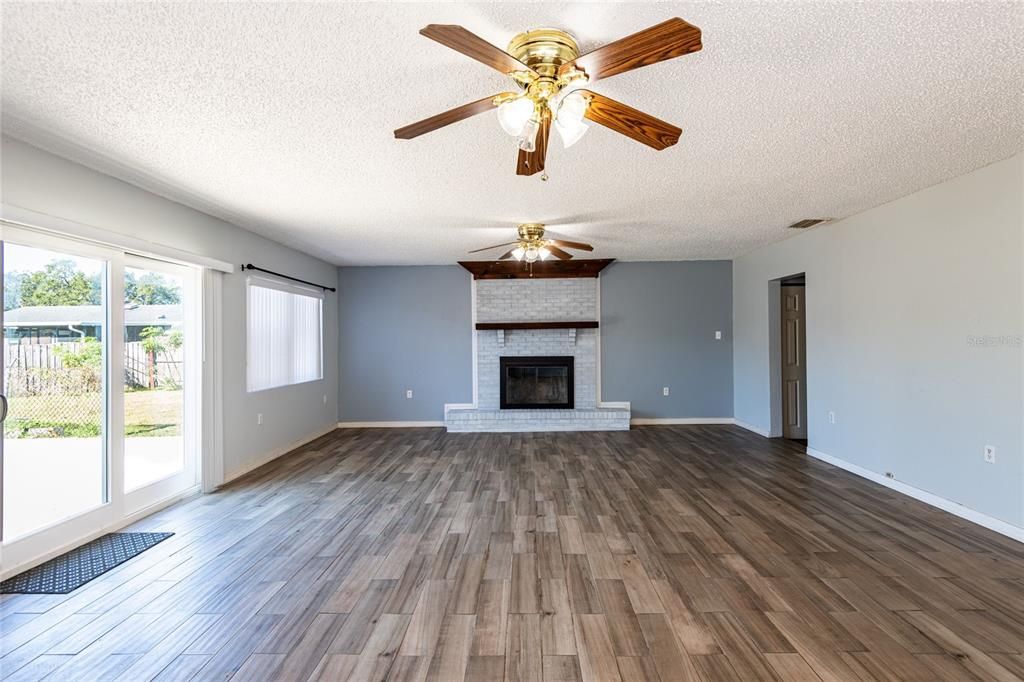 Huge Living Room with wood burning fireplace.