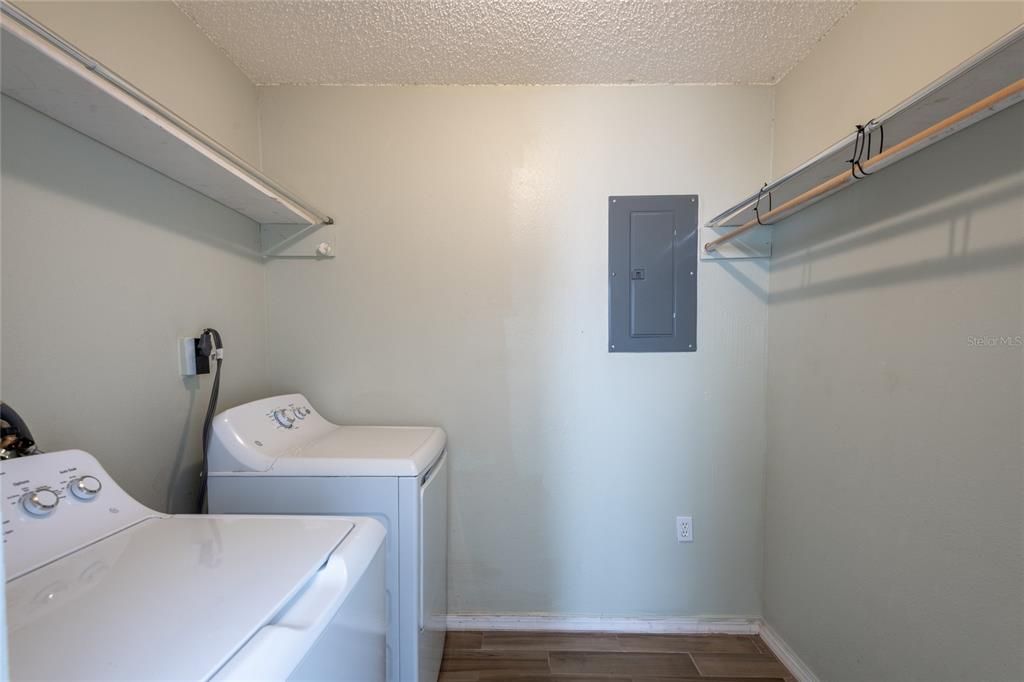 Walk-in closet with washer and dryer in the primary bedroom.