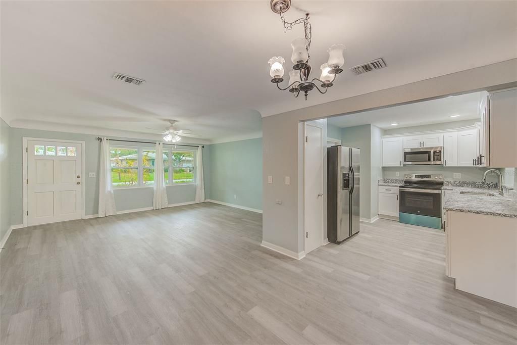 View of living room, dining room, and kitchen