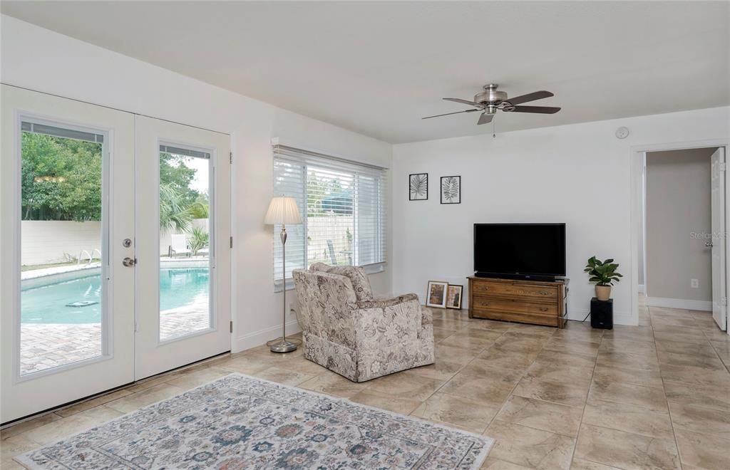 Family room off back of house with French doors to the pool and backyard