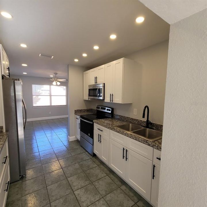 Double Sink, stove, and microwave, along with plenty of cabinets and counter space make this kitchen special.