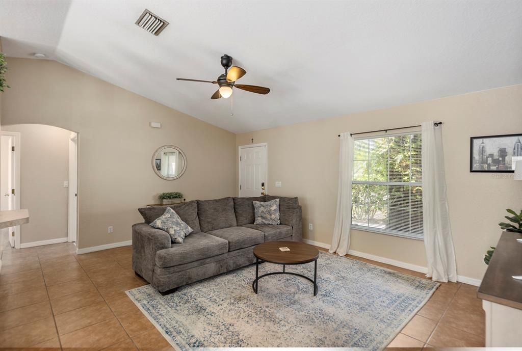 View of the living room from the dining room; open doorway leads to the guest bedrooms and bath