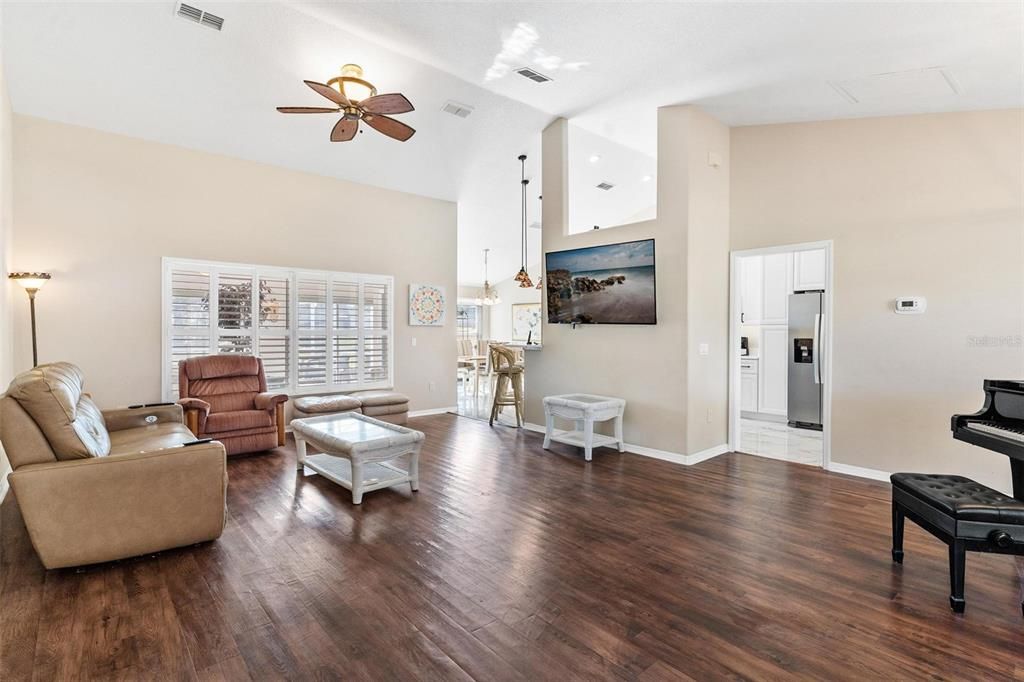 Living/Dining combo features engineered wood flooring, plantation shutters, and high ceilings.