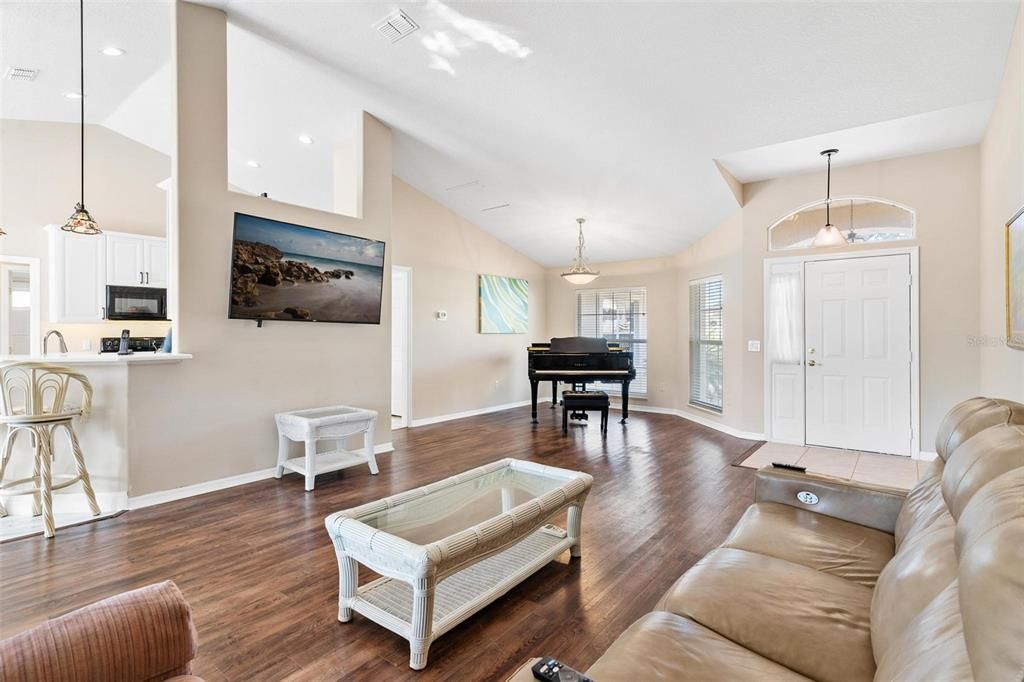 Living/Dining combo features engineered wood flooring, plantation shutters, and high ceilings.