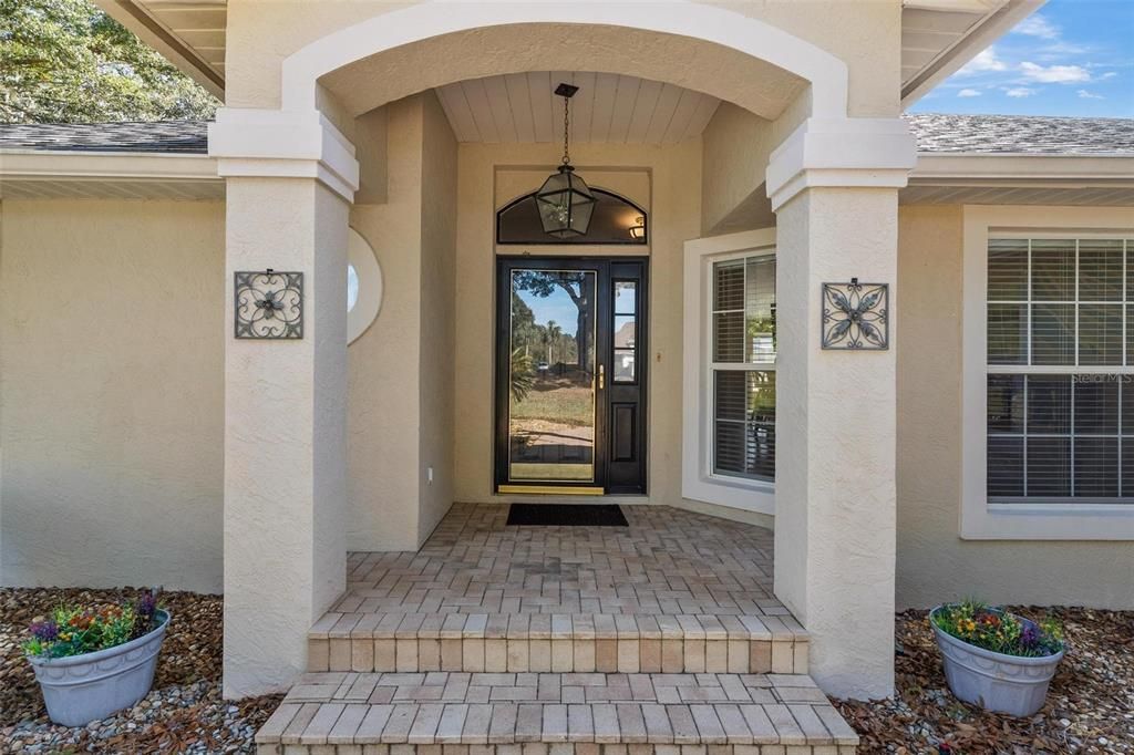 Exterior front porch leads to entry into home