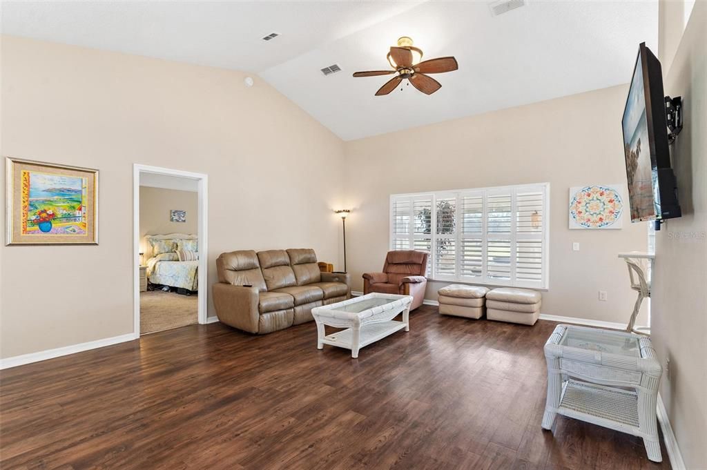 Living/Dining combo features engineered wood flooring, plantation shutters, and high ceilings.