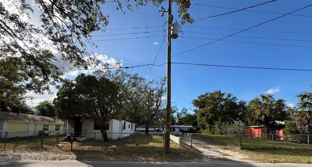 Street view of lot w/existing dwelling & other structure