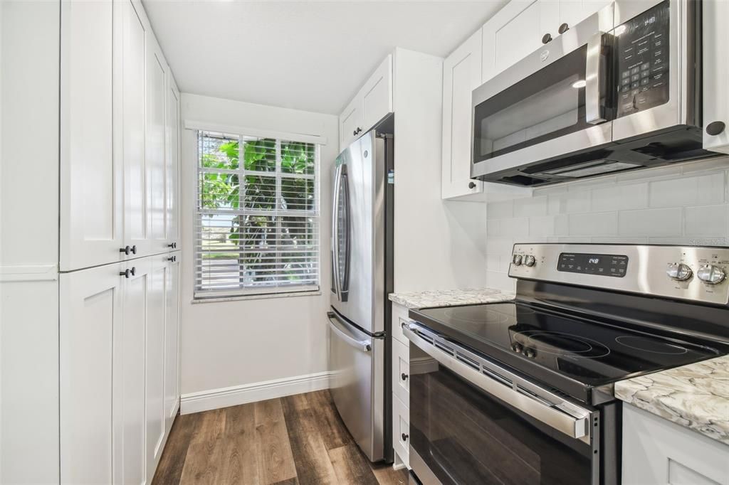 NEW LUXURY VINYL PLANK FLOORING THROUGHOUT, NEW KITCHEN WITH MODERN CABINETRY+HARDWARE, QUARTZ COUNTERTOPS, SS APPLIANCES, ADDITIONAL DRY GOODS PANTRY, LED LIGHTING, NEW HVAC, FRESHLY PAINTED INTERIOR.