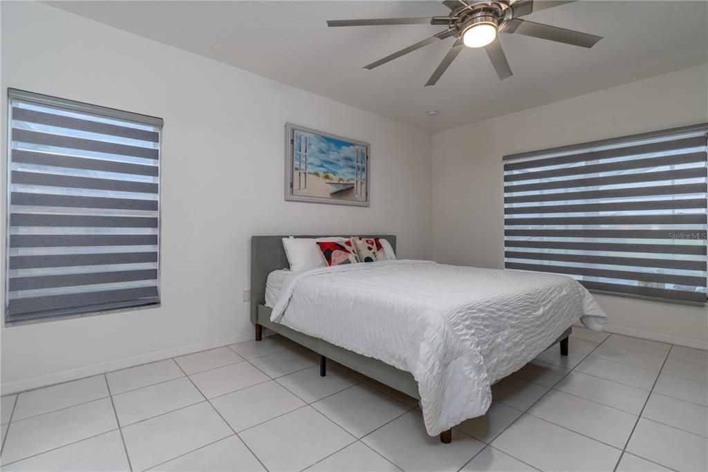 Primary bedroom with custom blinds