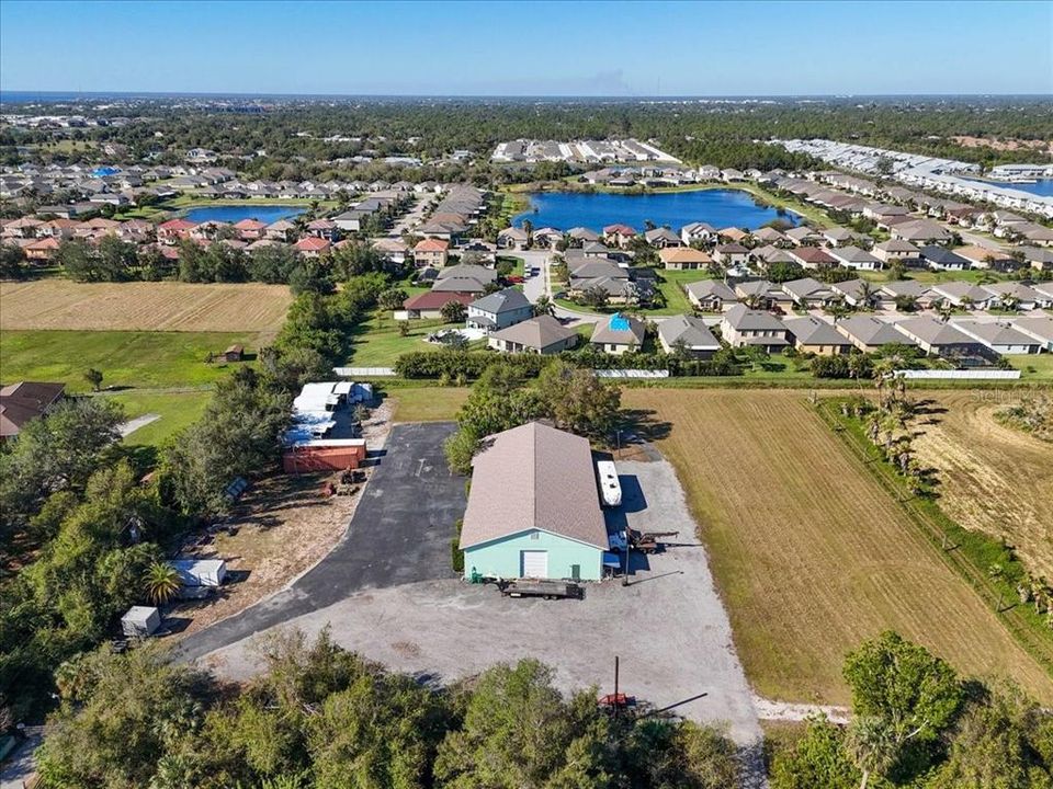 Aerial View of Commercial Building with Offices, Hobby Shop, Workshop/Garage and outbuildings with parking ports. Potential for Stables!