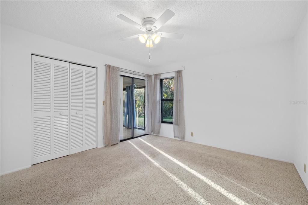 Primary Bedroom with sliders to the Florida room