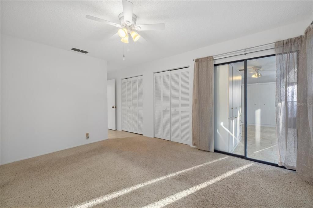 Primary Bedroom with sliding glass doors to the Florida room