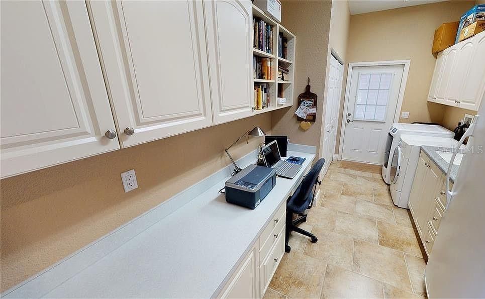 Laundry room with desk and shelving of guest house side of Duplex at Tall Palms Ranch