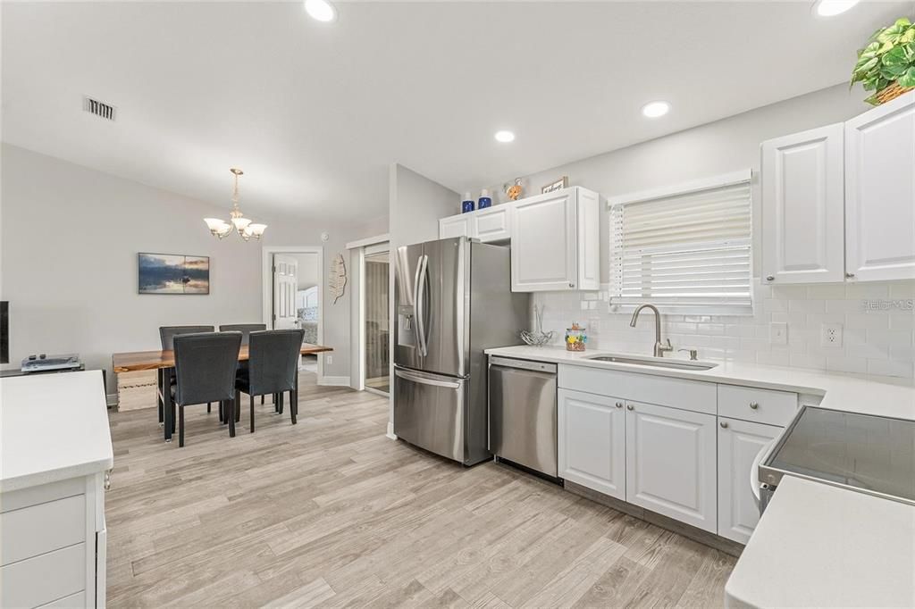 GORGEOUS TILED BACKSPLASH AND PLENTY OF CABINETS