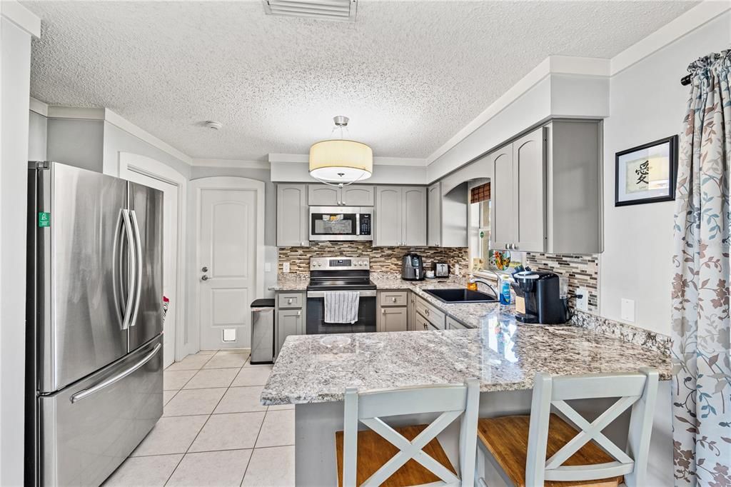 Kitchen with pantry door to the left and the door straight ahead leads to laundry room.