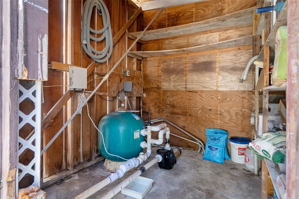 pool equipment and storage closet on side of detached garage