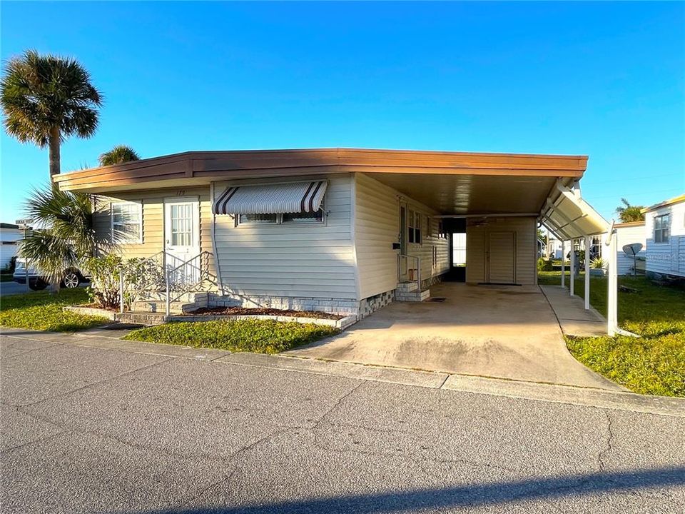 Tidy corner lot with charming front entrance and huge side carport!