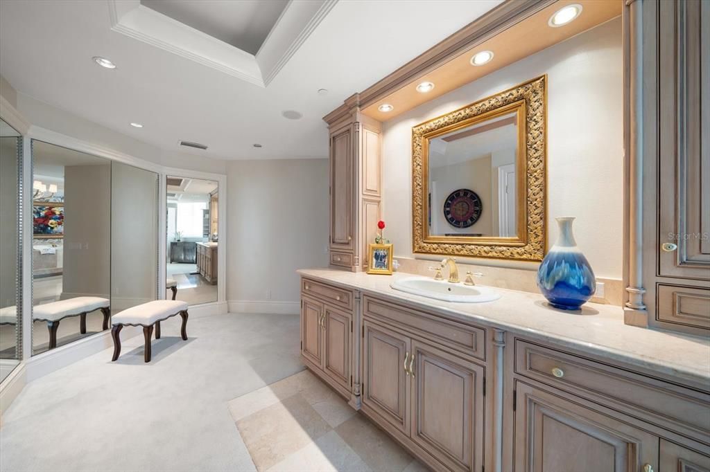 Separate dressing area with additional vanity and customized closets.