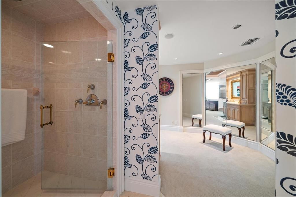 Primary bath has walk in shower adjacent to the dressing area