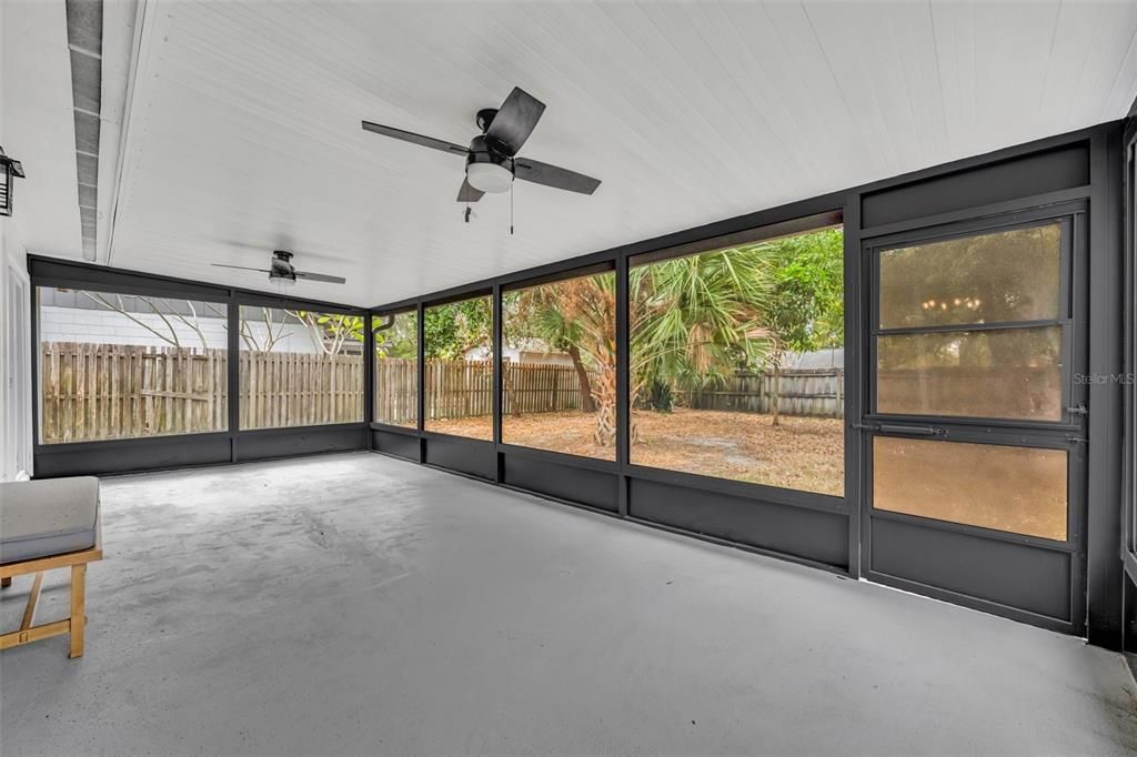 As we step outside from the dinning room this fully screened in patio let's you enjoy the outdoors big free.