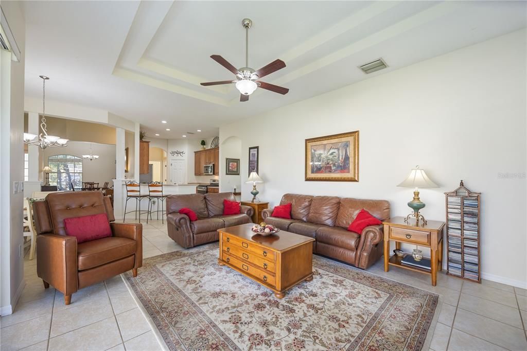 Family/Dining room combo with ceramic tile flooring and high tray ceilings.