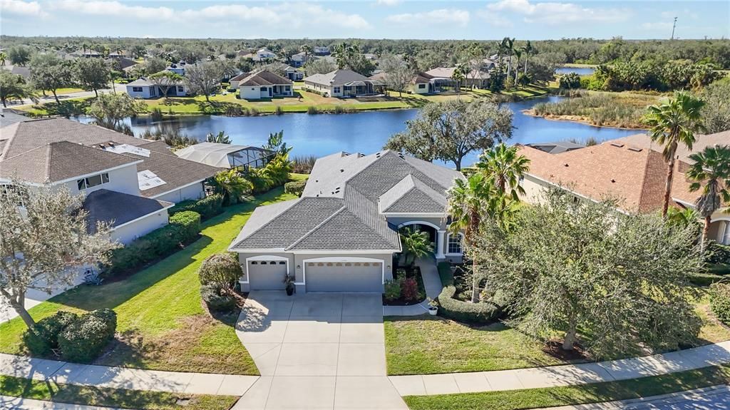 Nestled in Greyhawk Landing East with large serene lake view behind home