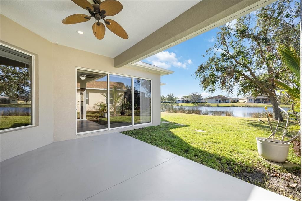 Open back lanai overlooks large serene lake perfect for lounging outside enjoying nature views