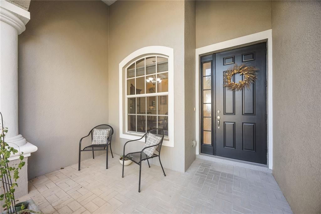 Spacious Covered front patio with seating area