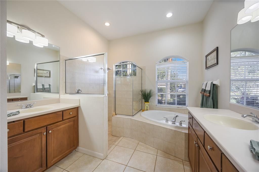 Ensuite primary bedroom with split double vanities, garden tub and a walk in roman shower.