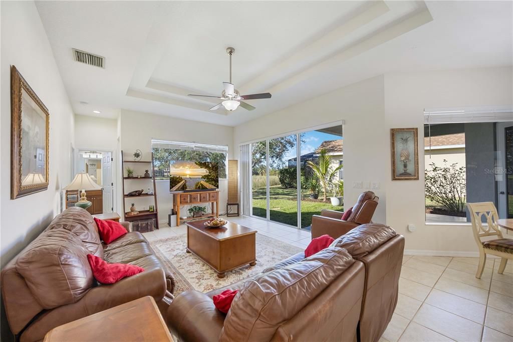 Family room connects through triple sliding doors to outdoor lanai.