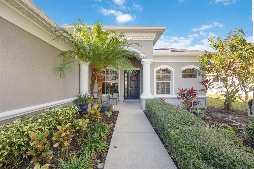 Lush greenery guides pathway to front entrance