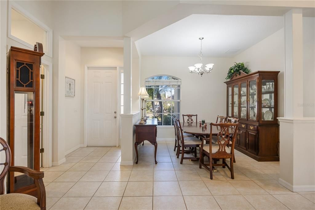 Inside front entrance with formal dining room to the left. Ceramic tile throughout home.