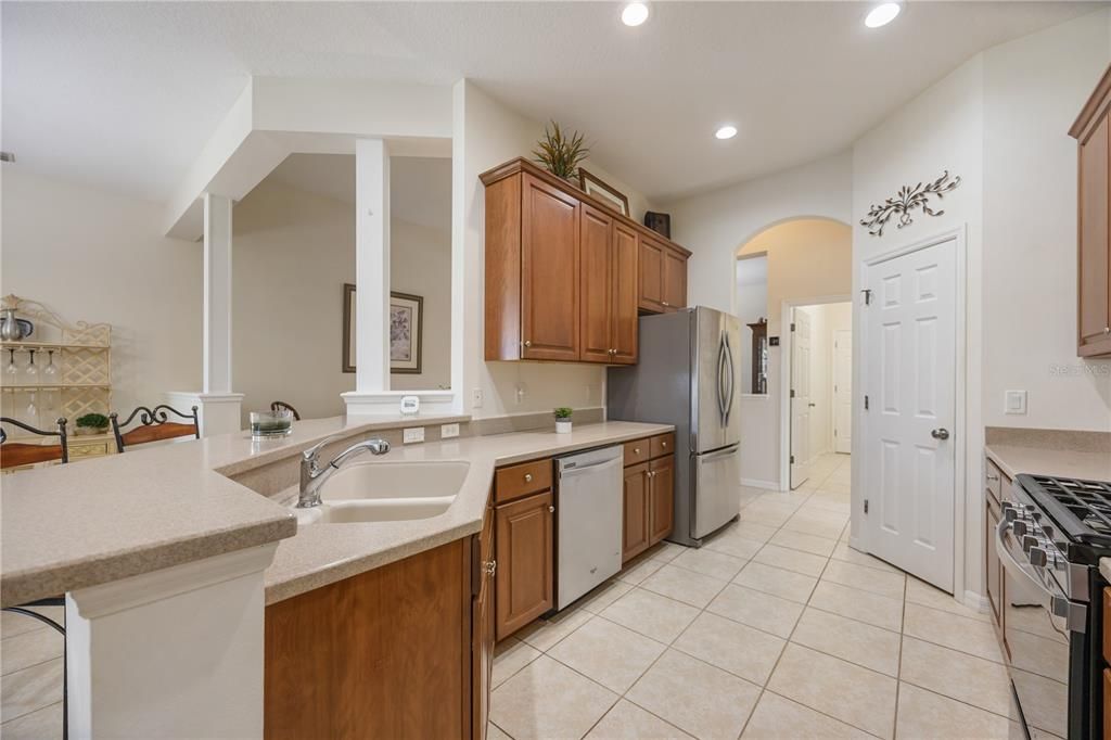 Open kitchen with 42" cabinets, stainless steel appliances, and large pantry