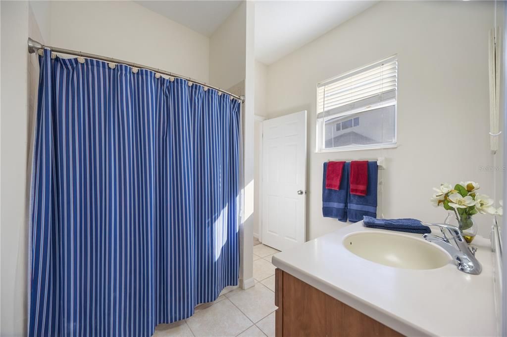 Guest bathroom connect to second bedroom with a second entrance to walk in from third bedroom or home's main area