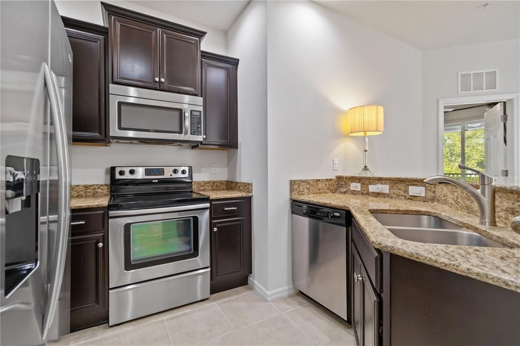 Kitchen with stainless steel appliances and granite countertops.