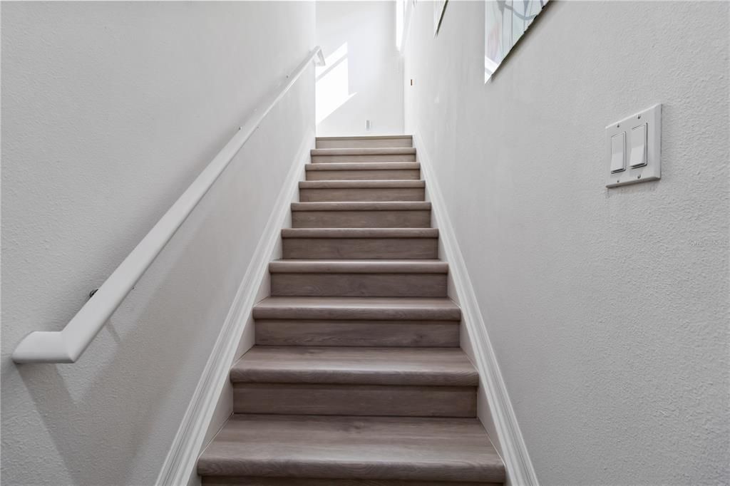 Stairwell leading Main floor of townhome Brand new Luxury Vinyl installed throughout home