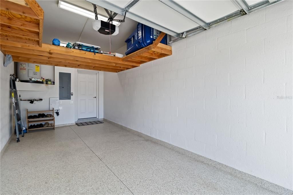 Spacious one car garage with epoxy flooring and overhead storage. Second entrance leading into home.