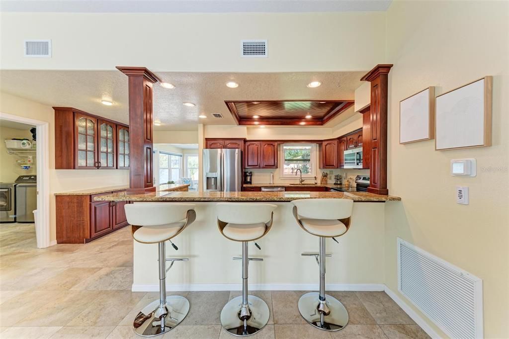 Expansive breakfast bar area looking into the kitchen area.