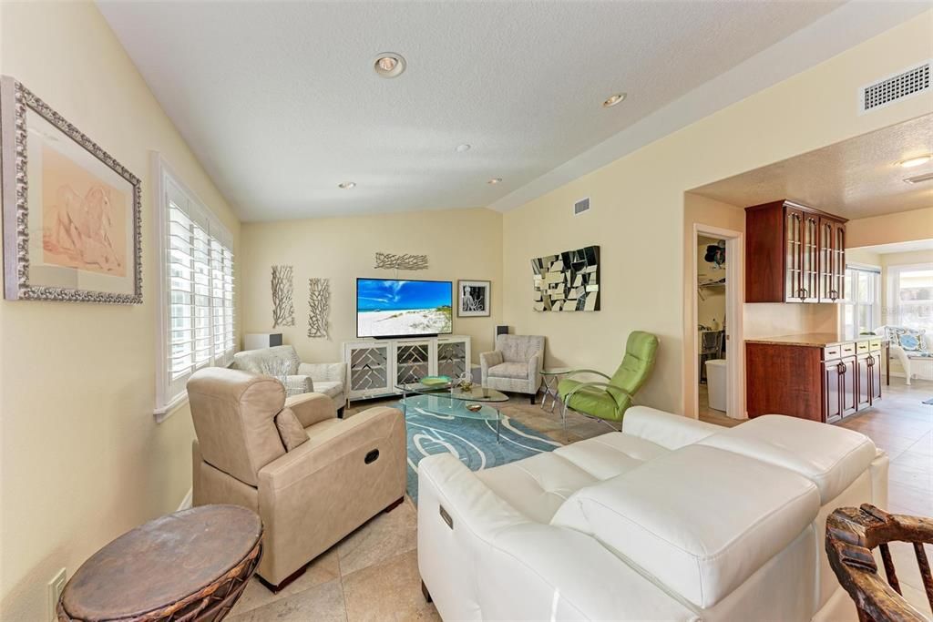 Spacious Great room with white plantation shutters.  Lots of natural light .