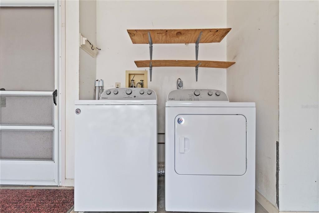 Off of the kitchen is the washer and dryer area.