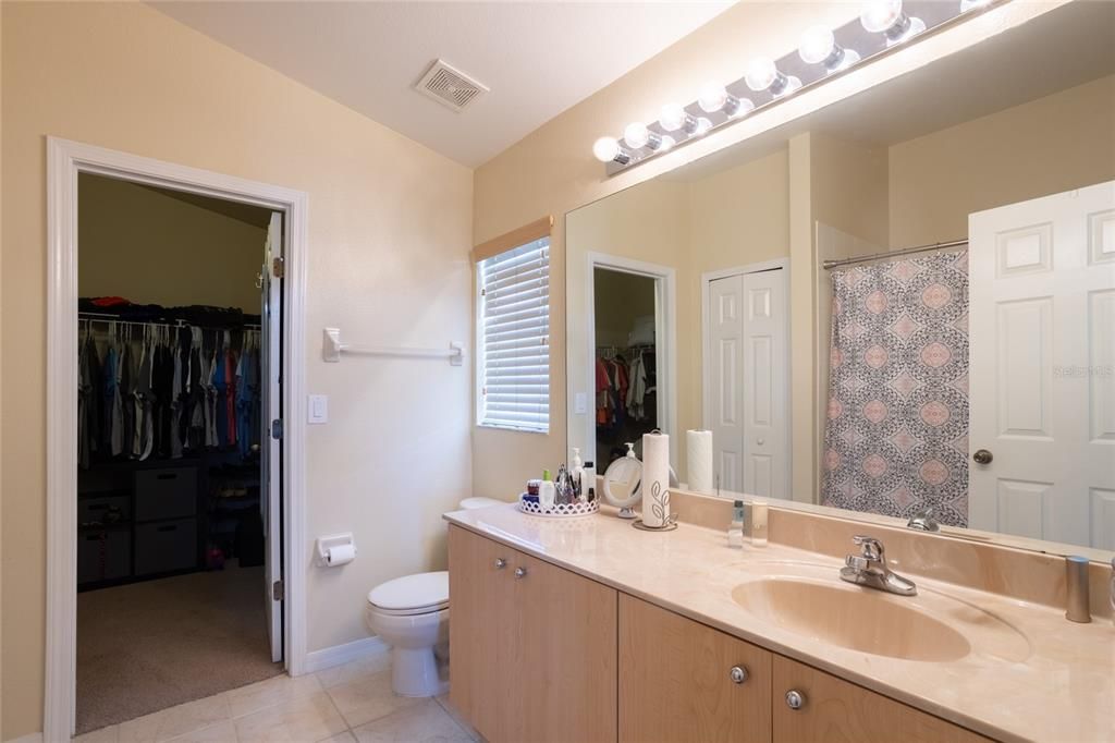 primary bath with spacious walk-in closet