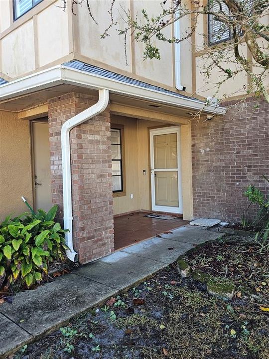 Front porch and side entry garage door.