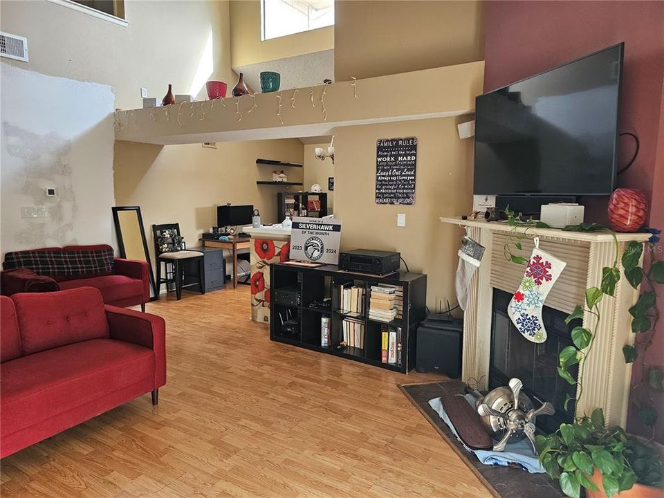 Living room with a wood burning fireplace.