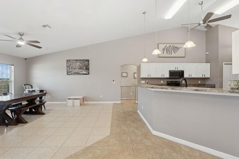 dinette looking into kitchen bar and family room area