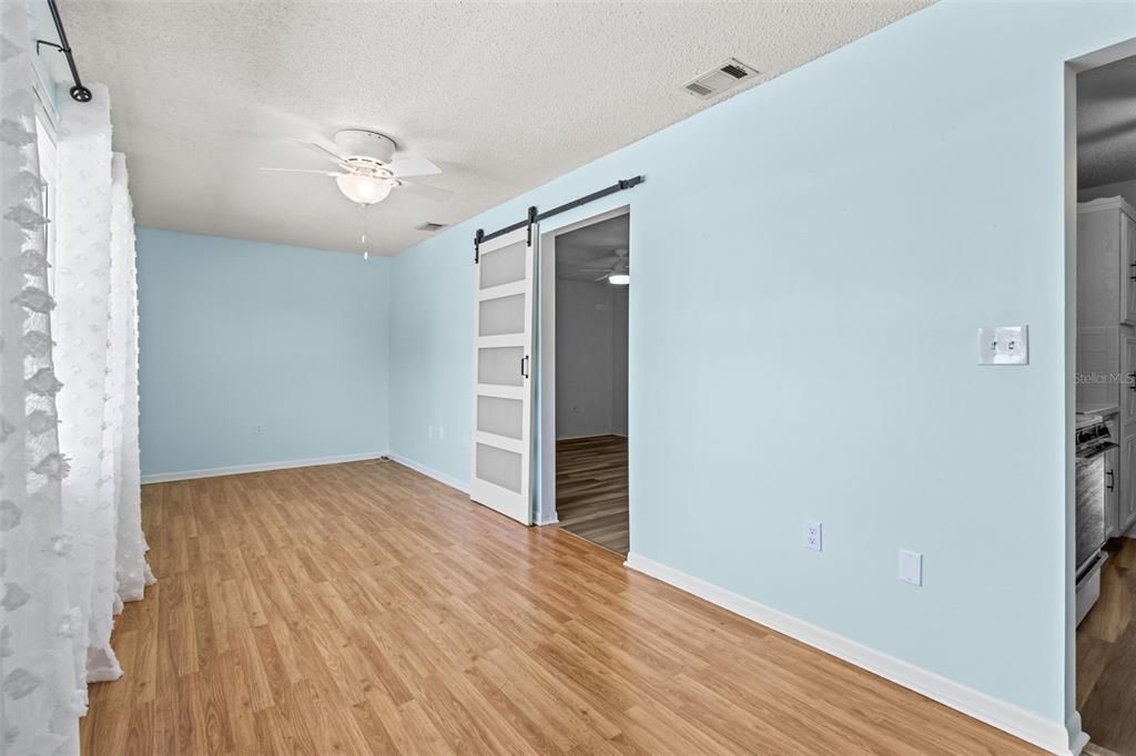 office/den barn door to primary bedroom