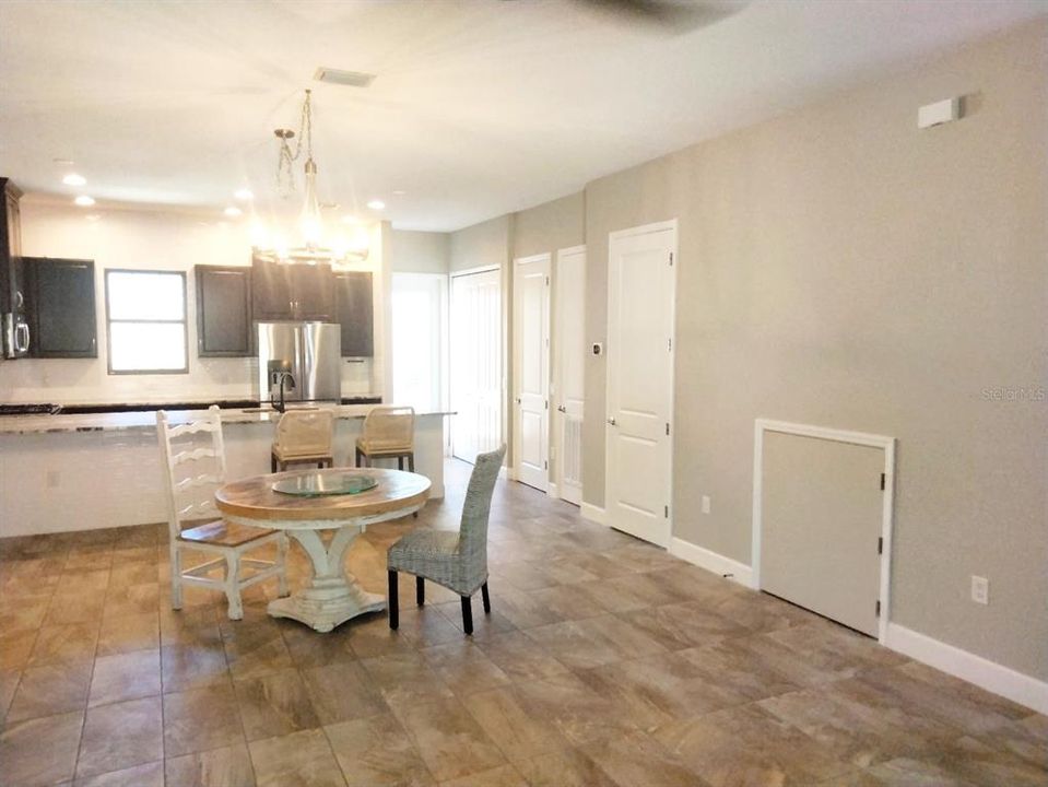 Large dining area and storage closet under stairs