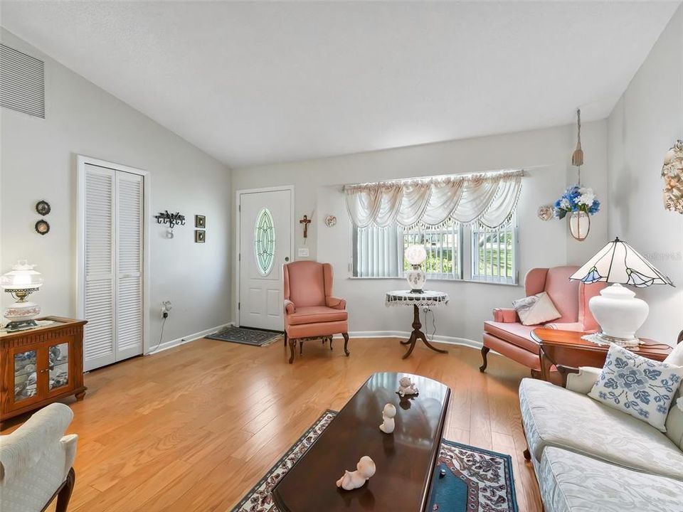 LIVING ROOM WITH BAY WINDOW AND COAT CLOSET