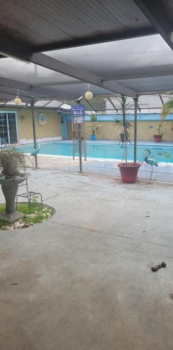 COVERED PATIO LOOKING OUT TO POOL